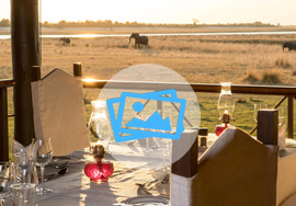 Dining on the deck with elephants in the background drinking at the waterhole