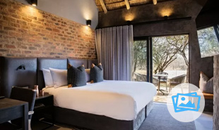 King size bed in bedroom with sliding doors leading to a view outside